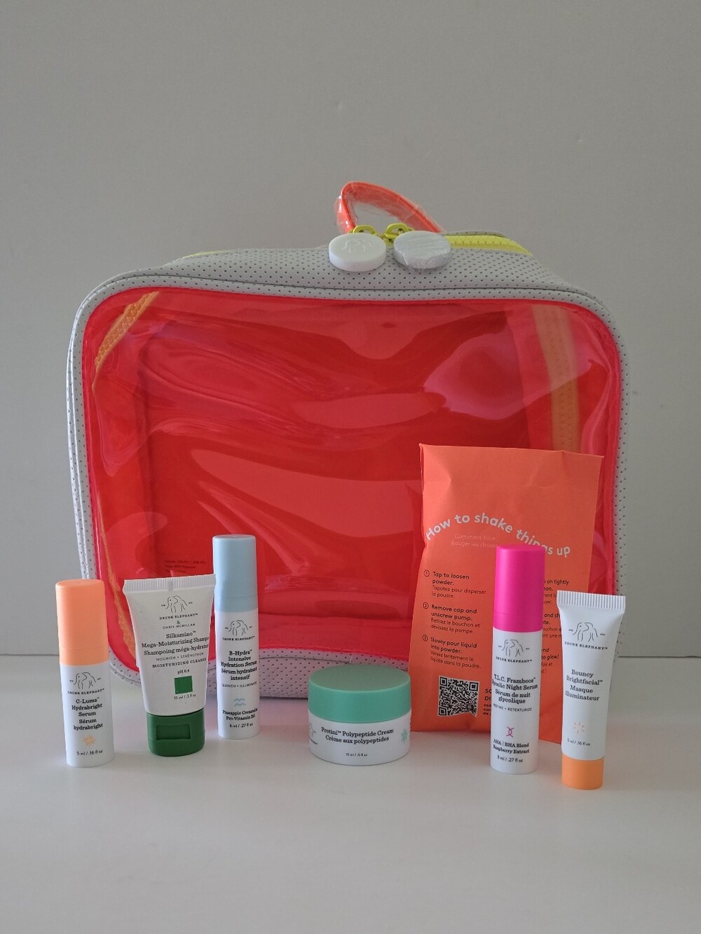 DRUNK ELEPHANT Dopp Kit with 7 travel size: shampoo, serum, cream, masque, neon